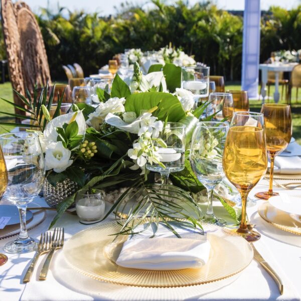 green wedding with white linens and golden glasses in puerto vallarta