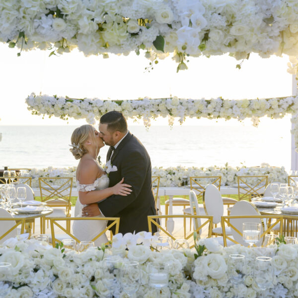 bride and groom in the middle of their flower arragement in puerto vallarta